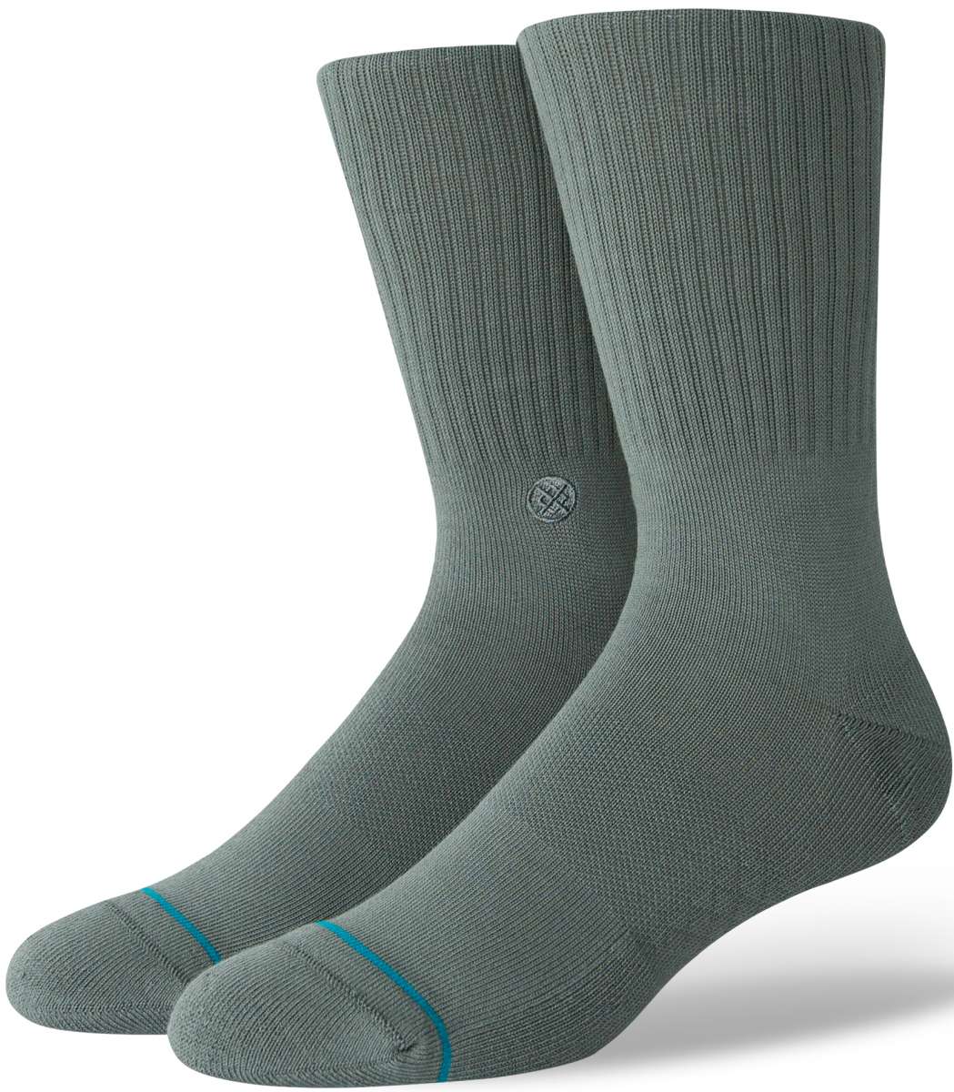 Stance Icon Crew Sock 2024 - A pair of gray crew socks with a small circular logo on the top of one sock's shin area.