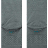 Stance Icon Crew Sock 2024 - A pair of gray crew socks with a repeating pattern of small, stylized icons in various colors.