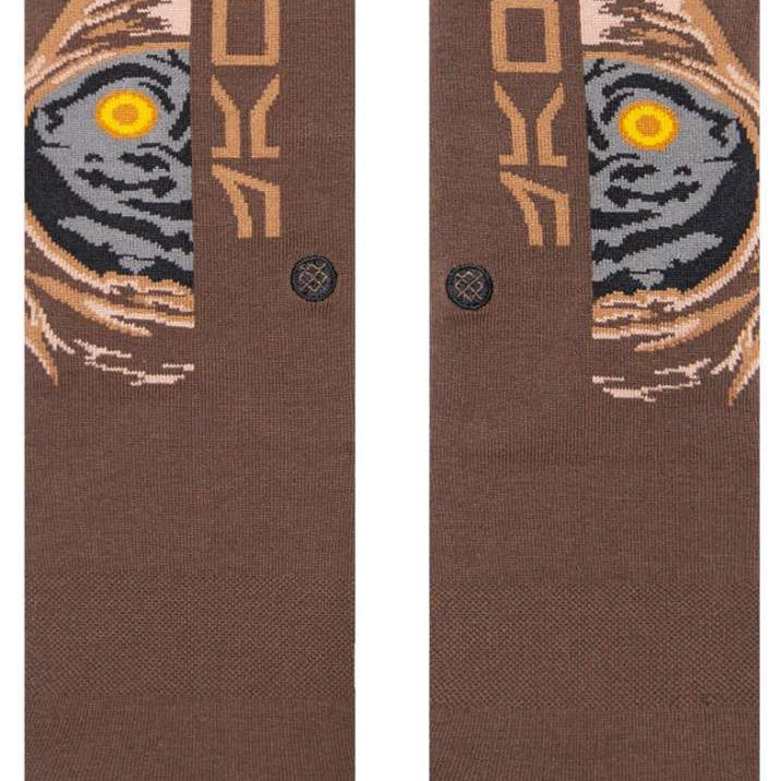 Stance Kids Jawa Crew Sock 2023 - A pair of brown crew socks with a stylized image of a character from Star Wars, possibly a young Jawa, in shades of gray and tan.