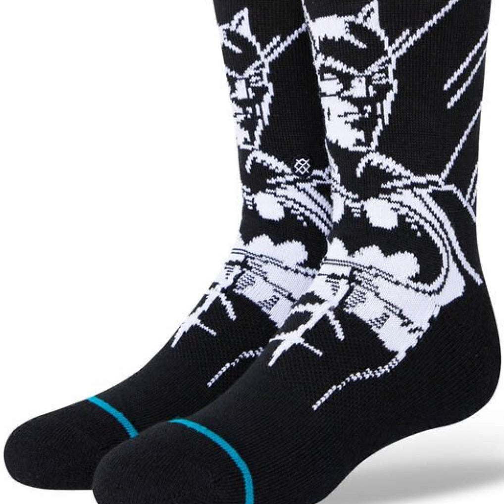 Stance Juniors Batman Crew Socks 2023 - A pair of black crew socks with a white graphic of Batman's face and logo on the top portion.