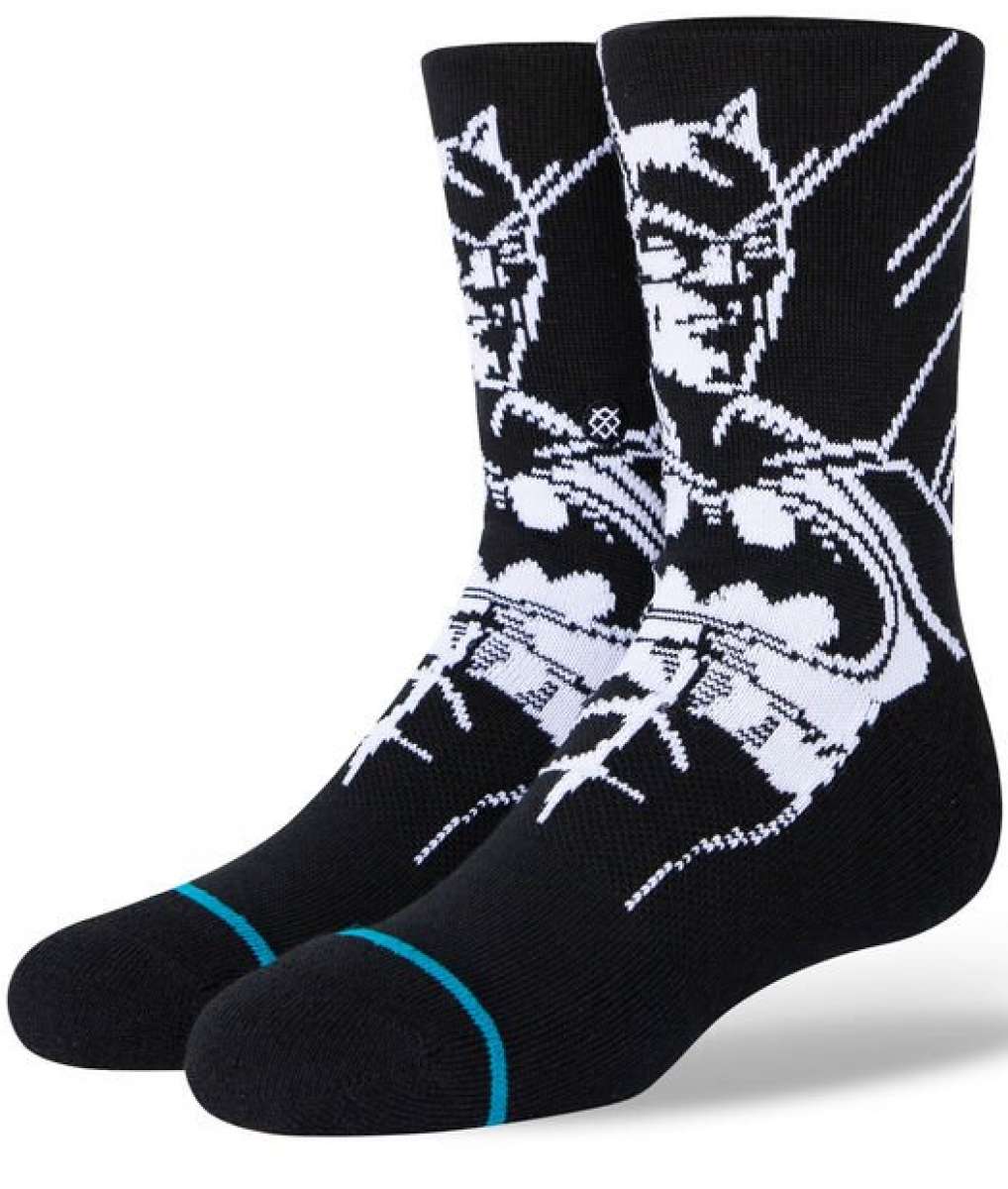 Stance Juniors Batman Crew Socks 2023 - A pair of black crew socks with a white graphic of Batman's face and logo on the top portion.