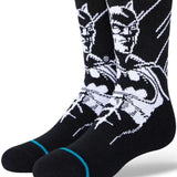 Stance Juniors Batman Crew Socks 2023 - A pair of black crew socks with a white graphic of Batman's face and logo on the top portion.