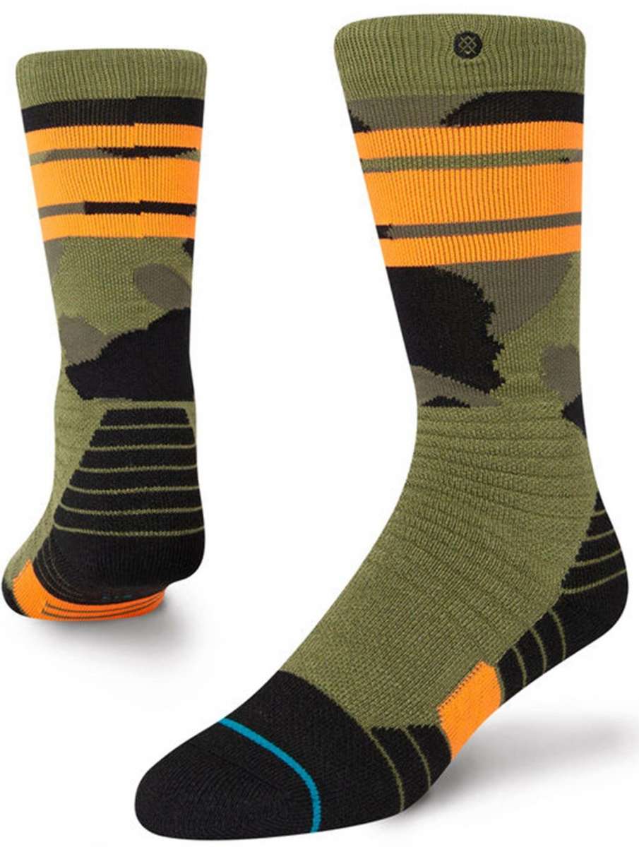 Stance Juniors Sargent Snow Sock 2023 - A pair of green snow socks with a black and orange stripe pattern on top.