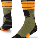 Stance Juniors Sargent Snow Sock 2023 - A pair of green snow socks with a black and orange stripe pattern on top.