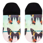 Stance Ladies' No Show Aflutter 2023 - Colorful butterflies with orange, yellow, and black wings on a light green background.
