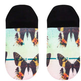 Stance Ladies' No Show Aflutter 2023 - Colorful butterflies with orange, yellow, and black wings on a light green background.