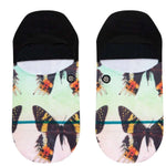 Stance Ladies' No Show Aflutter 2023 - Colorful butterflies with orange, yellow, and black wings on a light green background.