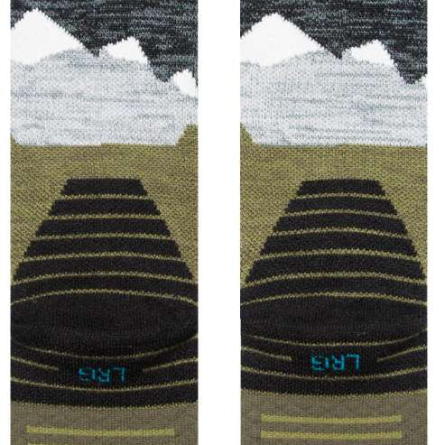 Stance - Lonely peaks design with snow-capped mountains in shades of white and gray on a green background.