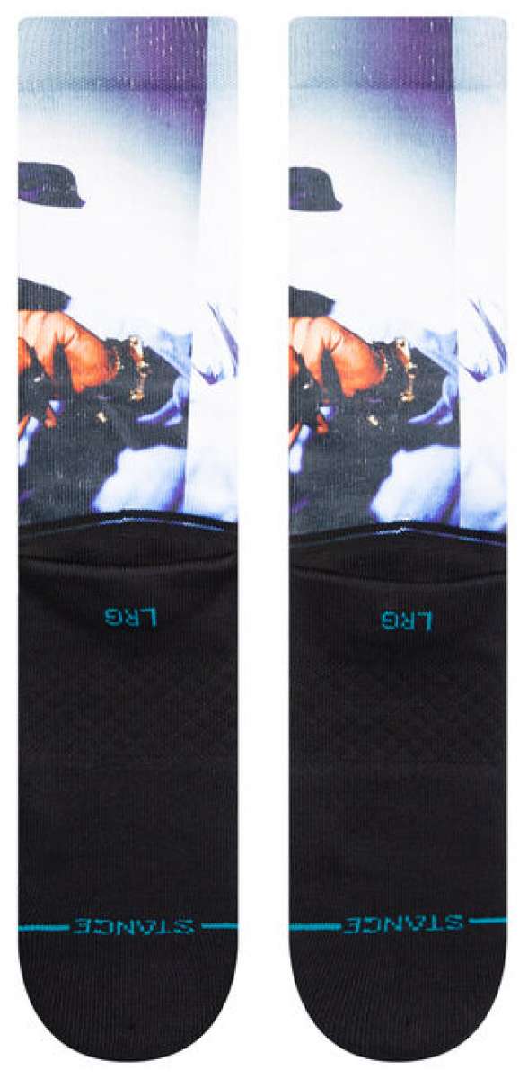 Stance Makaveli Crew Sock 2023 - A pair of white crew socks with a black graphic featuring a man's face and hat on the top portion.