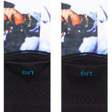 Stance Makaveli Crew Sock 2023 - A pair of white crew socks with a black graphic featuring a man's face and hat on the top portion.