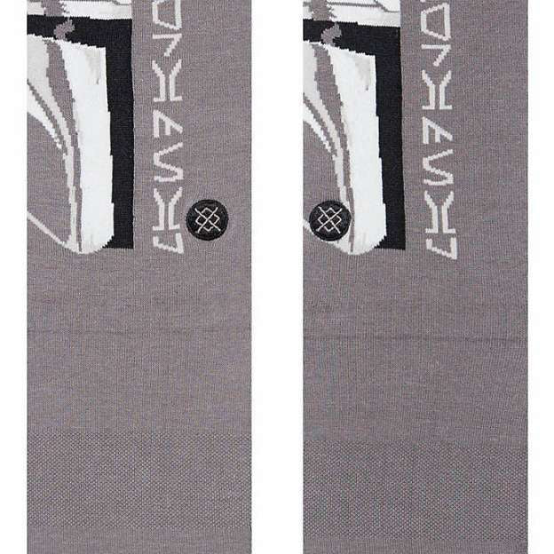 Stance Mando Crew Socks 2023 - A pair of gray crew socks with a white Mandalorian helmet graphic on the top portion.