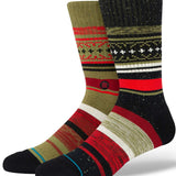 Stance Merry Merry Crew Sock 2024 - Red crew socks with green snowflakes and holly printed on them.