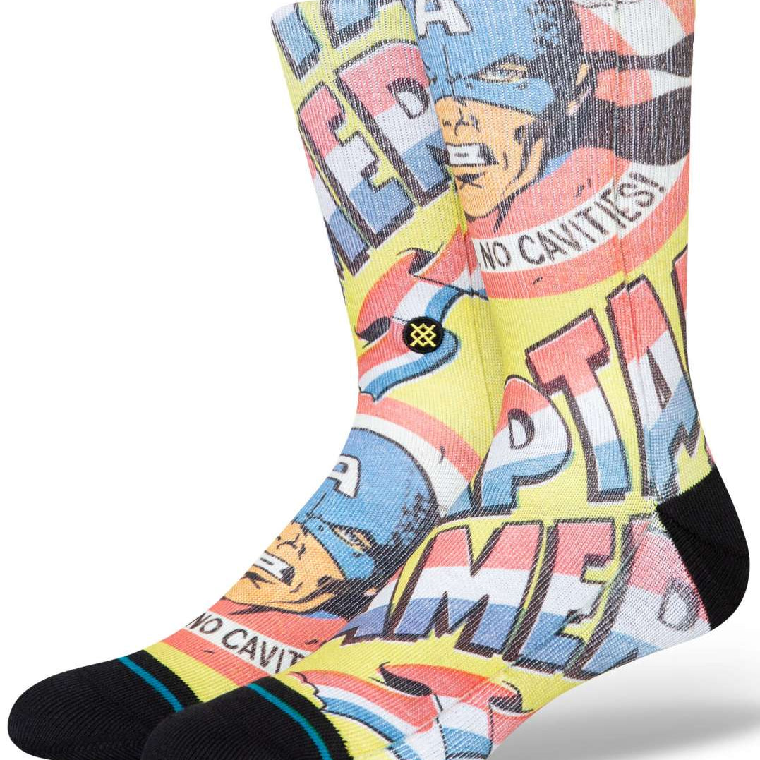 Stance No Cavities Crew Sock 2024 - A pair of crew socks with a blue and red design featuring Captain America's face, and the words "No Cavities" written in white letters on a pink background.