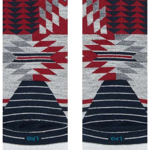 Stance Reaux Snowboard Socks 2023 - A pair of snowboard socks with a red, white and black geometric pattern on a gray background.