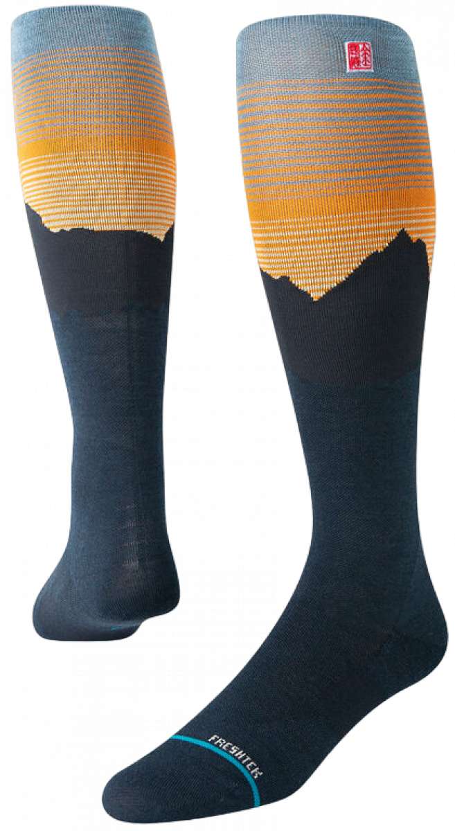 Stance Rising Snow SB Sock 2024 - A pair of snowboard socks with a rising sun design in shades of orange and yellow at the top, fading to gray towards the toes.