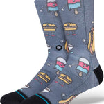 Stance - Seyclops Crew Sock 2024 is a gray crew sock with an all-over cartoon pattern of various food items, including hamburgers, hot dogs, and ice cream cones.
