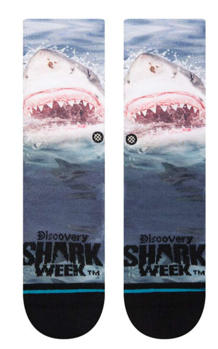 Stance Kids' Shark Week Crew Socks 2023 - A pair of crew socks with a shark design on them, featuring a large shark's head and teeth in shades of gray and white.