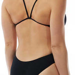 TYR Ladies' Durafast One Solids Cutoutfit Swimsuit - A black swimsuit with a cut-out design on the left hip, featuring thin straps and a high-cut leg.
