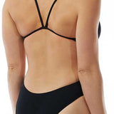 TYR Ladies' Durafast One Solids Cutoutfit Swimsuit - A black swimsuit with a cut-out design on the left hip, featuring thin straps and a high-cut leg.