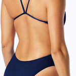 TYR Ladies' Durafast One Solids Cutoutfit Swimsuit - A navy blue swimsuit with a cut-out design on the side, featuring thin straps and a high-cut leg.
