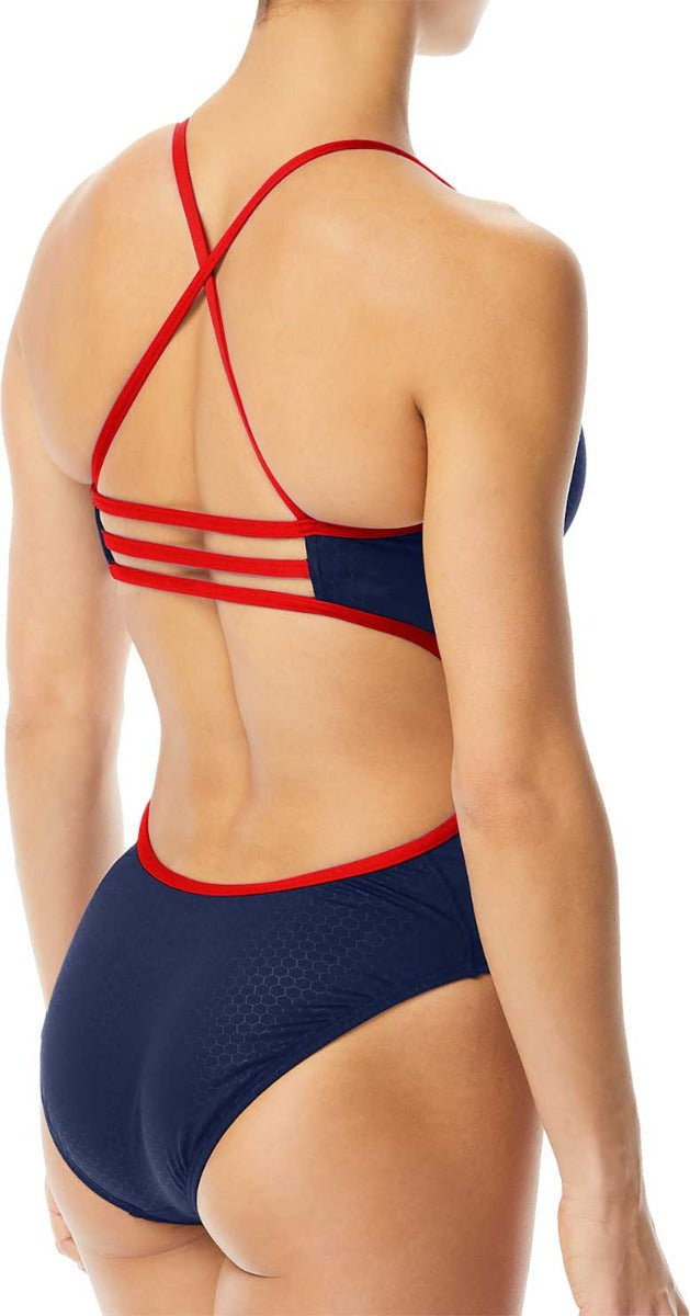 TYR Ladies' Hexa Trinityfit Swimsuit - A navy blue swimsuit with a geometric pattern on the front and back, featuring red straps that crisscross over the back.