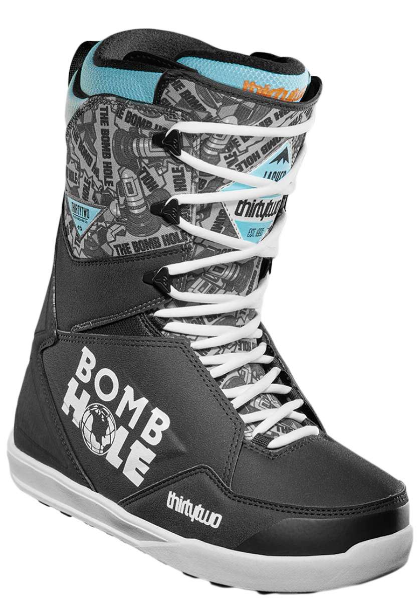 ThirtyTwo Lashed x Bomb Hole Snowboard Boots 2024 - A pair of snowboard boots with a black and white color scheme, featuring a repeating pattern of "Bomb Hole" logos in gray on the upper portion.