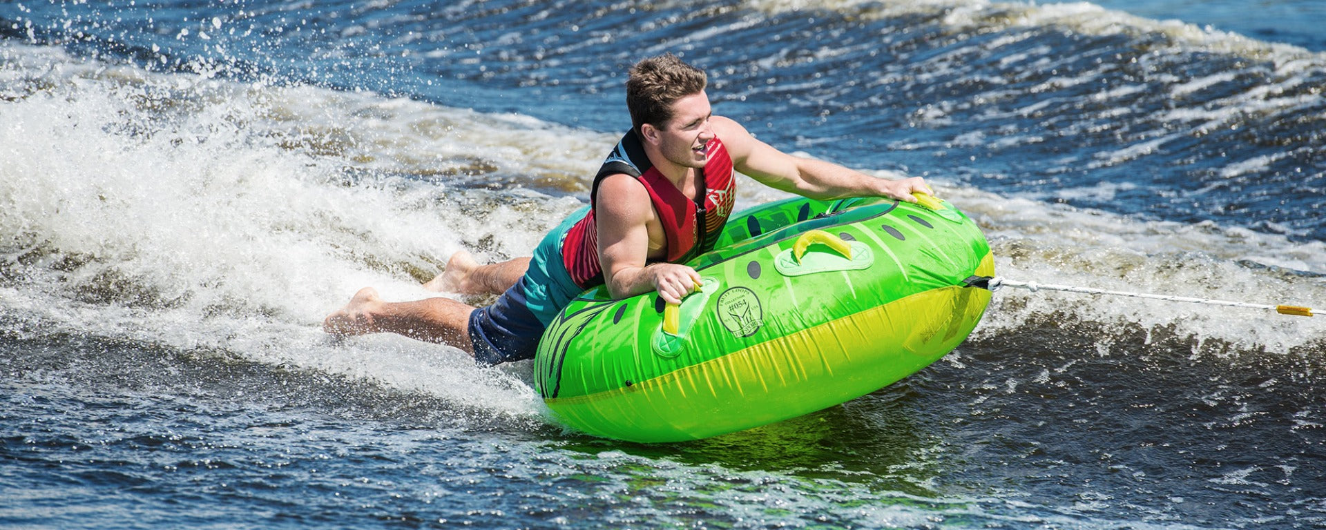 HO Sports Kiwi Inflatable Tube 2020 - Lime green inflatable tube with black and white stripes, featuring a smiling cartoon kiwi bird on its side.