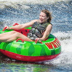 HO Sports Watermelon Inflatable Tube - A green watermelon with red seeds and a red rind, floating on dark blue water.