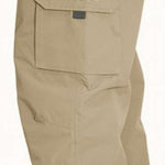 Turbine FDGB Shell Pant 2023 - Beige pants with a zippered pocket on the thigh and a logo patch on the upper left leg.