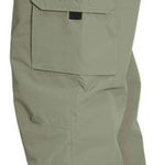 Turbine FDGB Shell Pant 2022 - A pair of khaki-colored pants with a red logo on the upper left pocket.