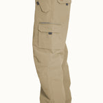 Turbine FDGB Shell Pant 2021 - A pair of khaki-colored pants with a zippered pocket on the thigh and a small logo patch near the waistband.