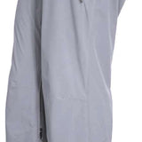 Turbine Women's Siren Shell Pant 2023 - Black pants with a subtle white snowflake pattern on the left leg, featuring a zippered pocket and adjustable waistband.