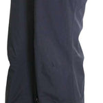 Turbine Women's Siren Shell Pant 2023 - Black pants with a shiny, smooth texture and a zippered pocket on the right thigh.