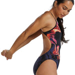 TYR Women's Cutoutfit Torch Swimsuit - A black swimsuit with a vibrant, abstract red and orange design on the torso area.