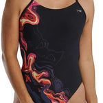 TYR Women's Cutoutfit Torch Swimsuit - A black swimsuit with a colorful, abstract design featuring shades of pink, orange, and yellow on the left side.