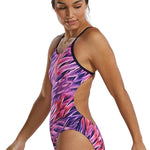 TYR Women's Cutoutfit Falcon Swimsuit - A pink, purple, and black swimsuit with a tropical leaf pattern on the torso and hips.