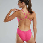 TYR Ladies Lapped Cutoutfit Suit - A pink one-piece swimsuit with a cut-out design on the sides and thin straps.