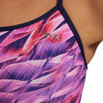TYR Women's Trinifyfit Falcon Swimsuit - A pink and purple swimsuit with a pattern of abstract shapes resembling feathers or wings.