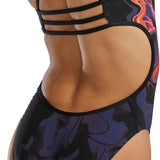 TYR Women's Trinityfit Torch Swimsuit - A black swimsuit with a red and orange flame design on the right side, featuring a high-cut leg and low back.