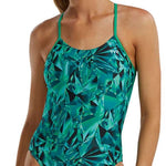 TYR Women's Crystalized Cutout Swimsuit - A woman with brown hair pulled back into a ponytail, wearing this swimsuit that features a green and blue abstract pattern of geometric shapes.