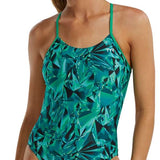 TYR Women's Crystalized Cutout Swimsuit - A woman with brown hair pulled back into a ponytail, wearing this swimsuit that features a green and blue abstract pattern of geometric shapes.