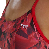 TYR Women's Crystalized Cutout Swimsuit - A red swimsuit with a geometric pattern and cutouts on the sides, featuring a white logo that says "TYR" in the center of the chest area.
