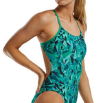 TYR Women's Crystalized Cutout Swimsuit - A women's swimsuit with a cutout design on the hips, featuring a geometric pattern in shades of blue and green.