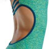 TYR Women's Lapped Trinityfit Swimsuit - A green and yellow swimsuit with a textured pattern, featuring thin straps that crisscross over the back.