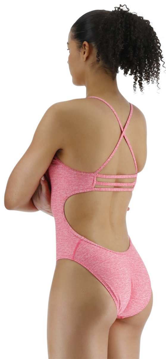 TYR Women's Lapped Trinityfit Swimsuit - A pink swimsuit with a lapped design and thin straps, worn by a woman facing away from the camera.
