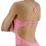 TYR Women's Lapped Trinityfit Swimsuit - A pink swimsuit with a lapped design and thin straps, worn by a woman facing away from the camera.