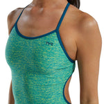 TYR Women's Lapped Trinityfit Swimsuit - A women's swimsuit with a blue and yellow patterned design, featuring thin straps and a small black logo on the upper left side.