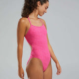 TYR Women's Lapped Trinityfit Swimsuit - A pink one-piece swimsuit with thin straps and a high-cut leg.