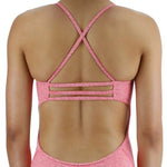 TYR Women's Lapped Trinityfit Swimsuit - A pink swimsuit with a lapped design and thin straps, worn by a model facing away from the camera.