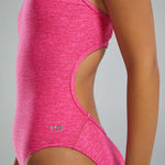 TYR Women's Lapped Trinityfit Swimsuit - A pink one-piece swimsuit with a cut-out on the side and a small silver logo that reads "TYR" in the center of the hip area.